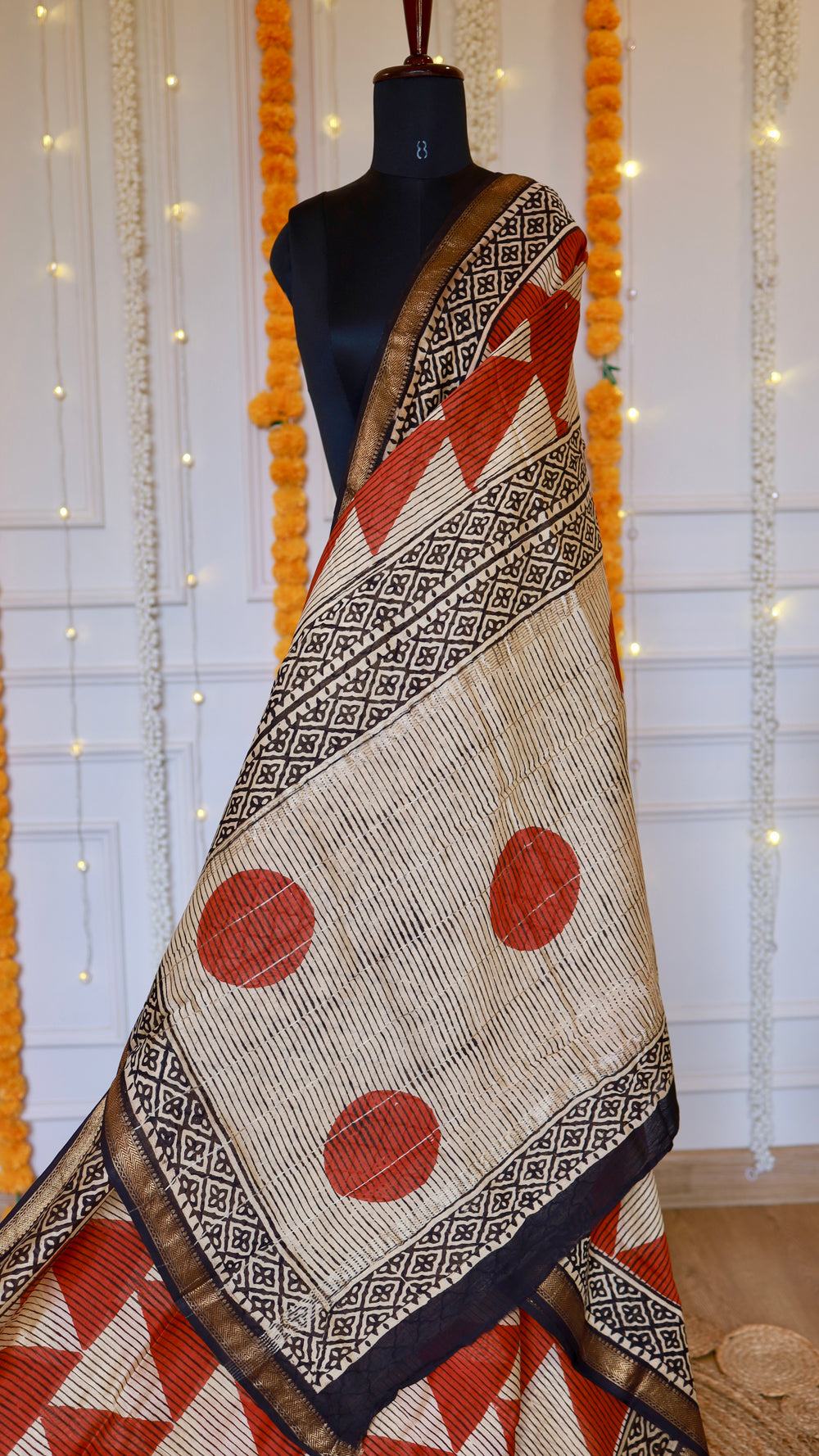 Handblock printed pallu featuring rust orange polka dots and black floral tile borders on Maheshwari silk saree