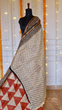 Full-length view of beige lattice-patterned body and rust geometric pleats on Maheshwari silk saree
