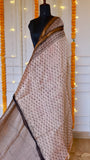 Rear pleat view of light beige Maheshwari silk saree displaying subtle floral hand block motifs