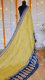 Full length drape of mustard yellow Maheshwari silk saree displaying royal blue contrast pallu and delicate border layout.