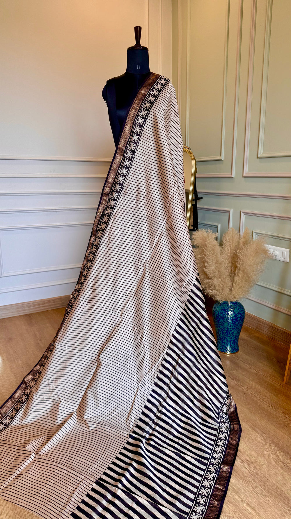 Full-length view of Titafu Maheshwari Silk Saree with ivory and black stripes displayed on a mannequin.