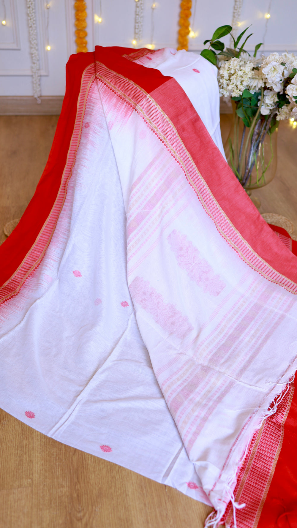 Full drape display of off-white Cotton Bomkai Saree revealing the plain solid red blouse piece and woven pallu details