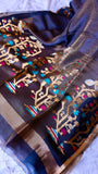 Full layout view of midnight blue pure silk linen saree pallu displaying dense handwoven golden tree motifs.