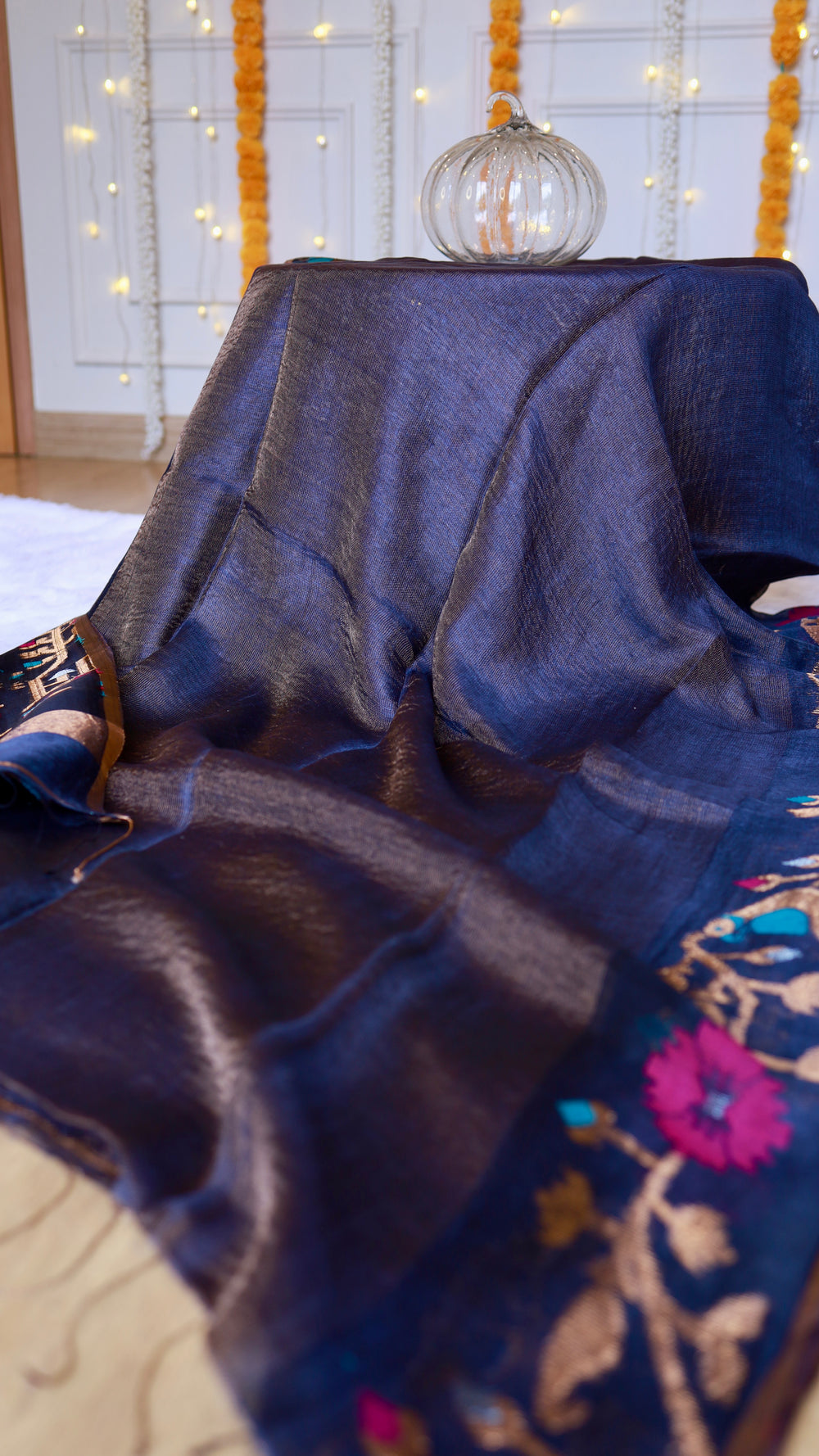 Soft drape of pure silk linen saree showing luxurious metallic sheen and dark indigo blue texture.