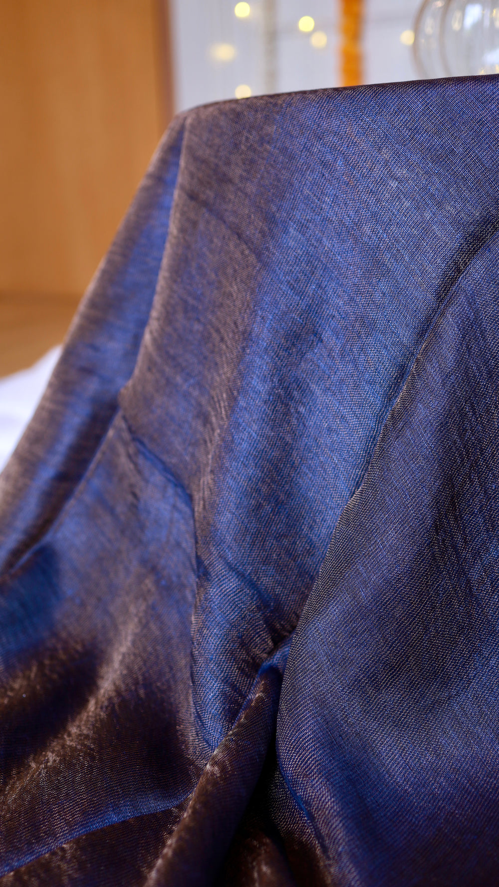 Macro close-up texture view of handwoven midnight blue pure silk linen fabric weave.