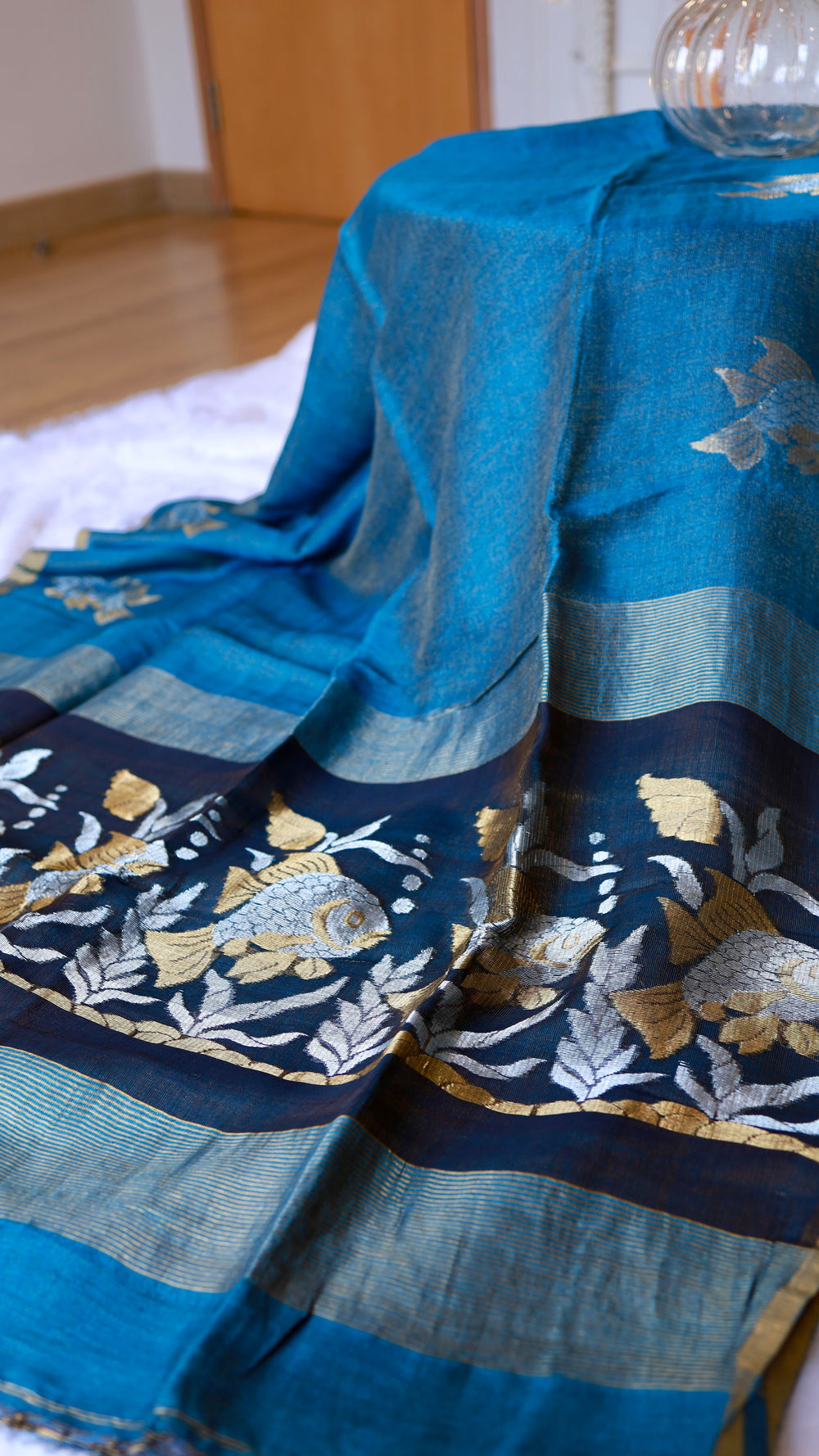 Full drape view of blue Pure Silk Linen Saree highlighting the contrasting dark navy fish motif pallu.