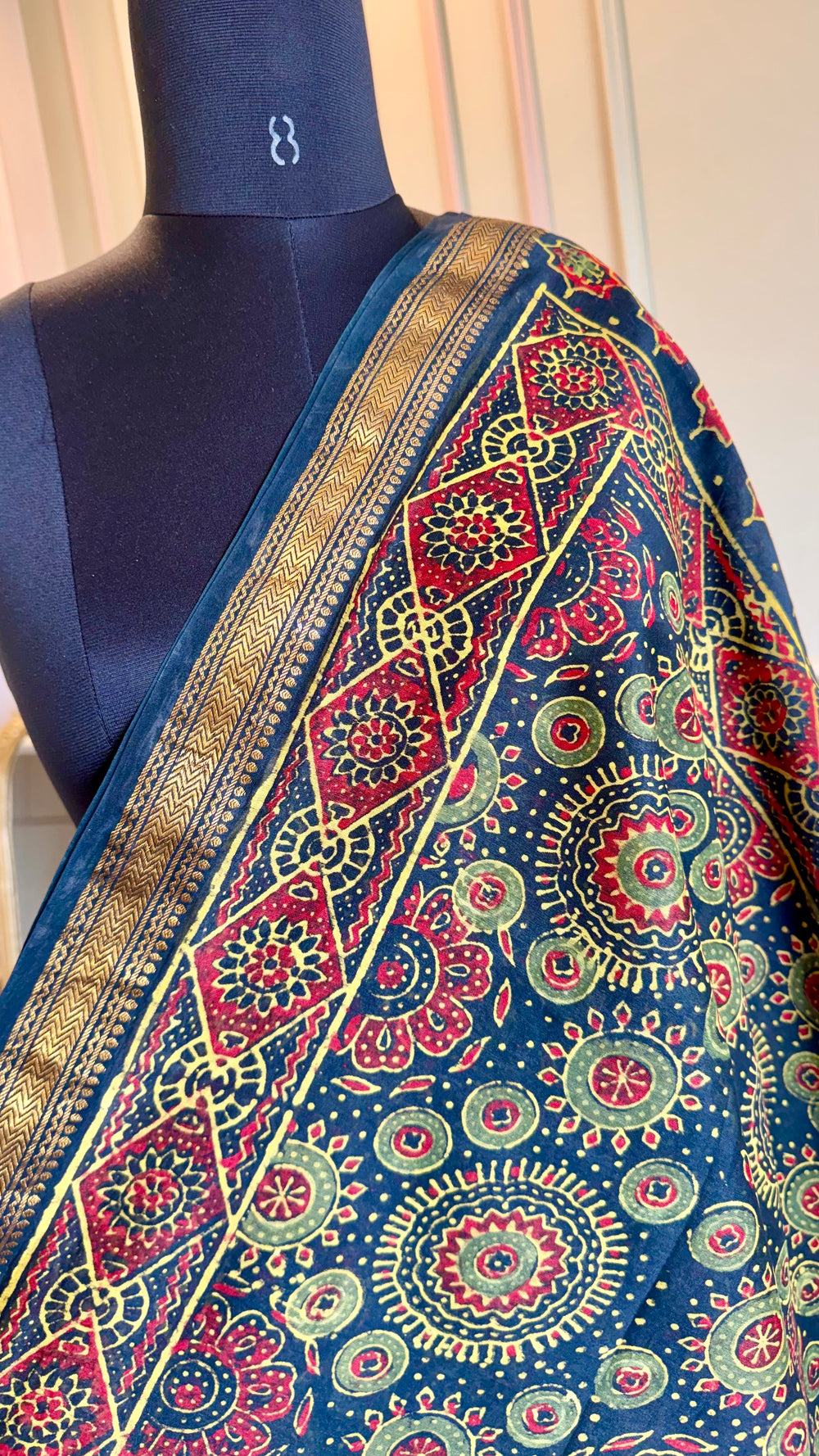 High-resolution macro shot of the circular mandala motifs and texture of the Maheshwari weave.