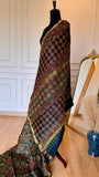 Full drape of teal and rust Maheshwari saree on a mannequin showing the elegant fall and pleats.