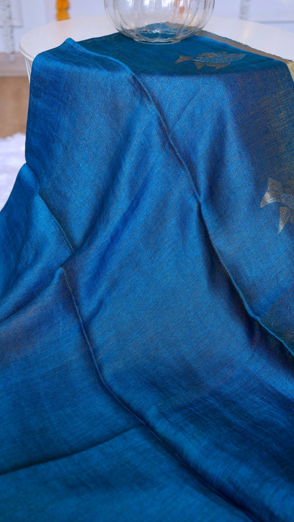 Sheer sheen and rich texture of peacock blue Pure Silk Linen Saree fabric draped softly.