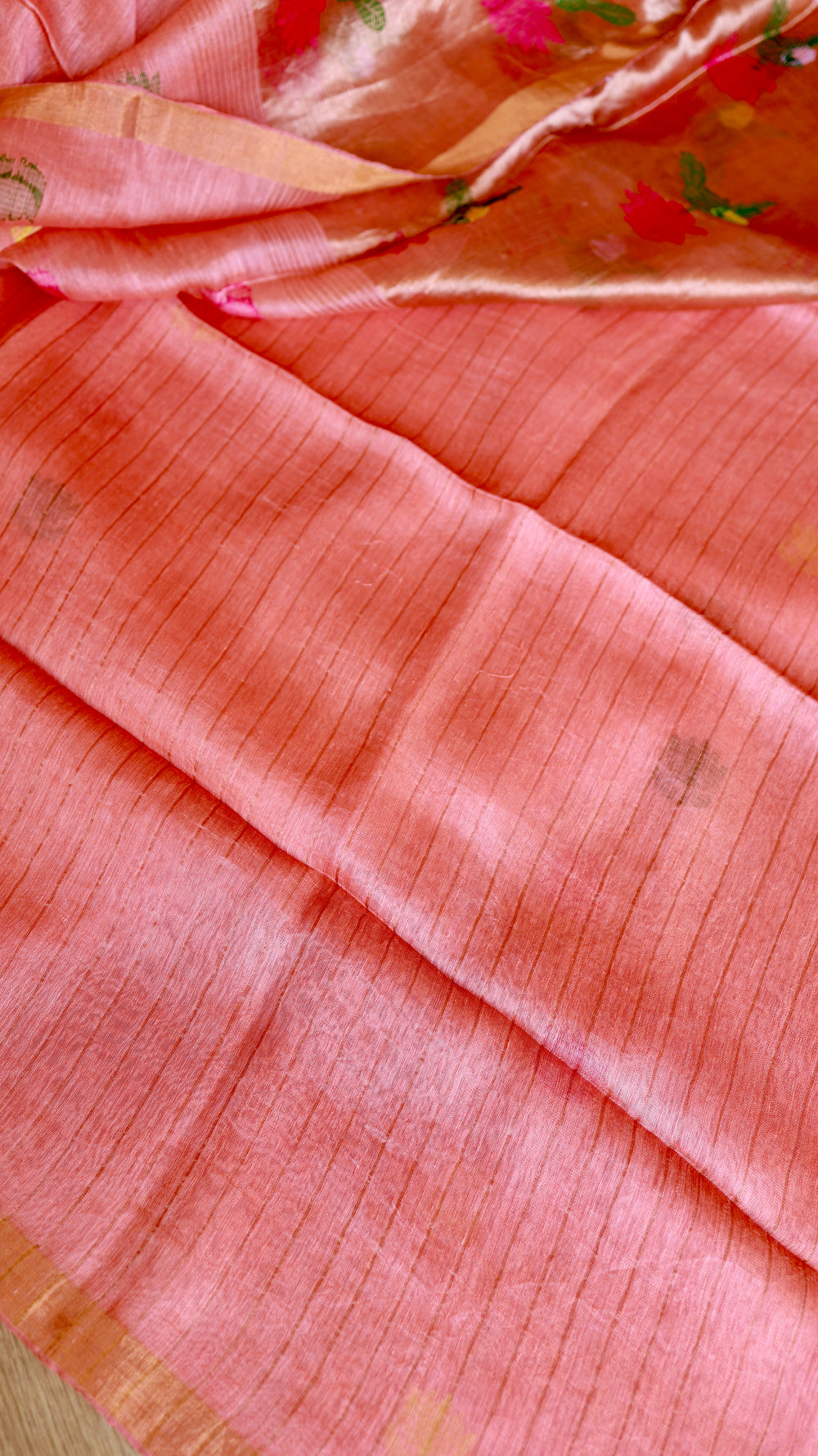 Detailed view of matching peach silk linen blouse piece fabric with woven line texture