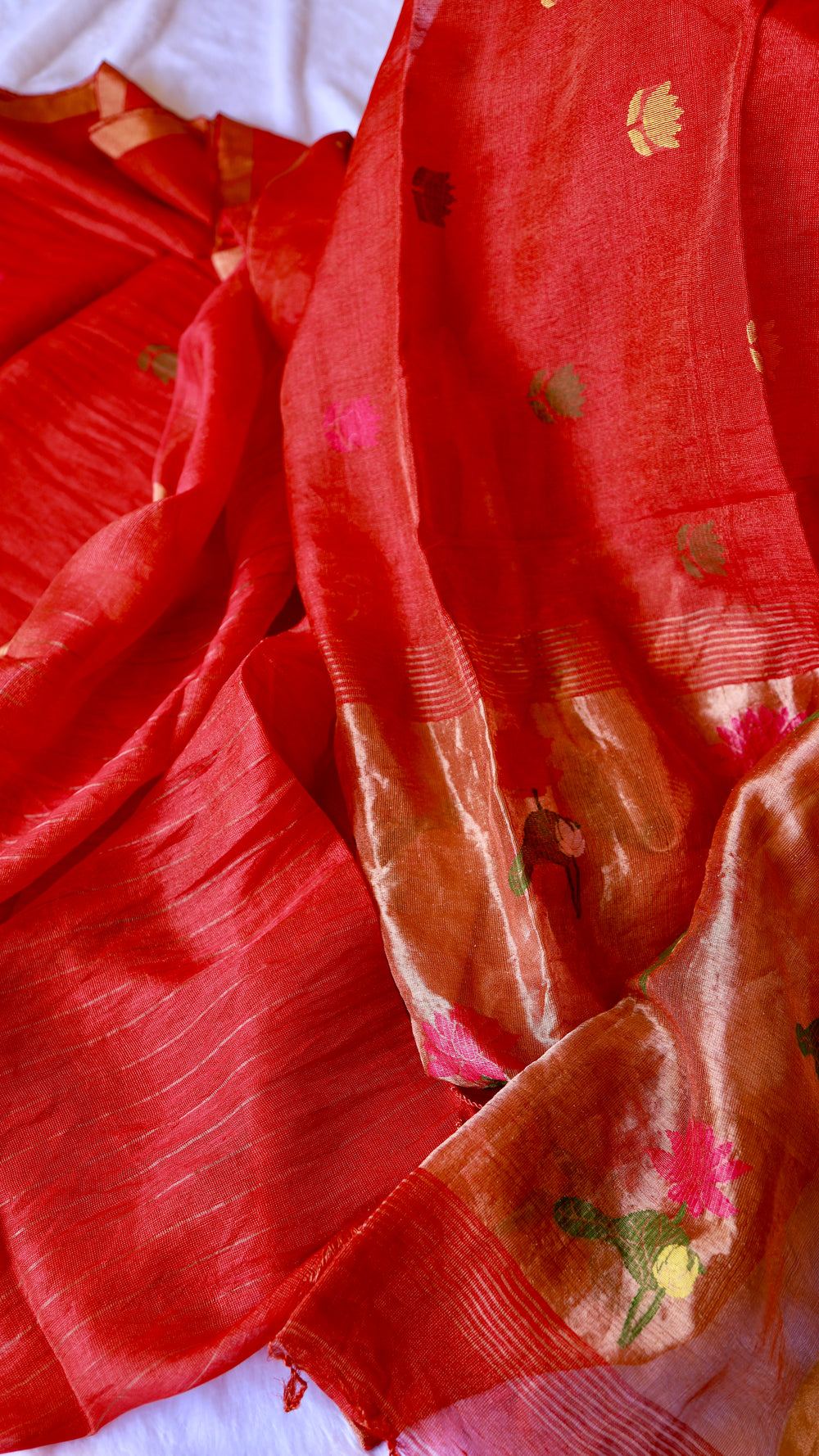 Full view of the pallu section of the saree, featuring dense and beautiful handwoven pink, green, and yellow floral Jamdani embroidery.