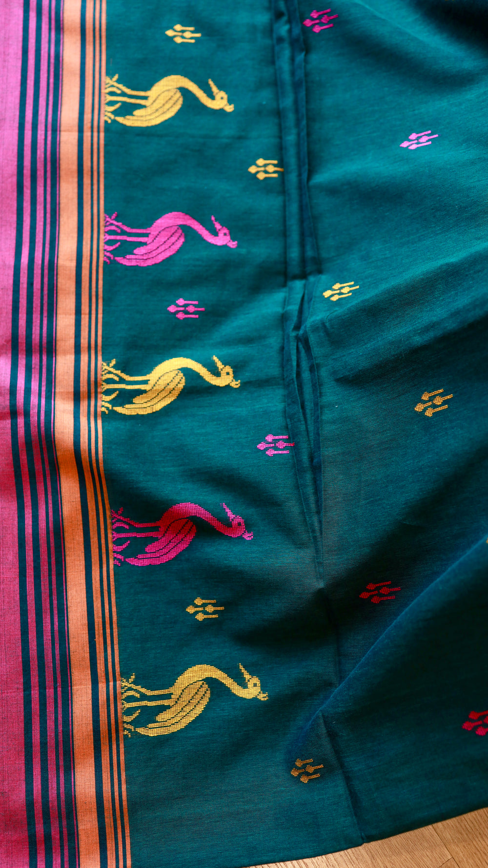 Straight view showing the body pattern and small contrast butis on the Titafu bottle green handwoven Khadi cotton saree.