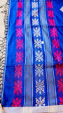 Close-up of the geometric floral woven border on royal blue handwoven khadi cotton fabric.