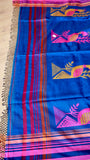 Close-up of Royal Blue Khadi Cotton Saree pallu showing woven peacock motifs in pink and gold with fringe detailing.
