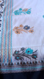 Detailed shot of handwoven floral motif on breathable white Khadi cotton weave.