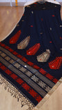 Full length view of midnight black handwoven khadi cotton saree with crimson and beige paisley pallu motifs and hand-tied tassels.