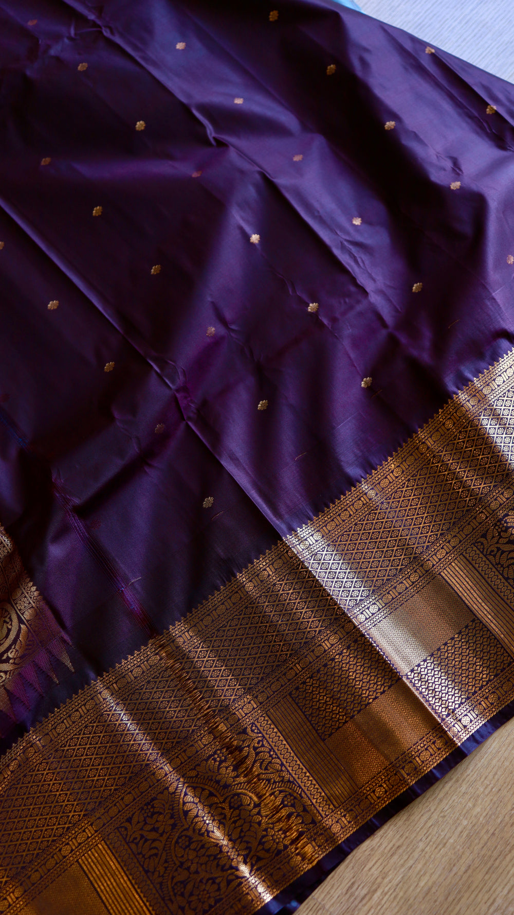 Deep purple blouse piece material with gold zari borders for sky blue semi Gadwal saree