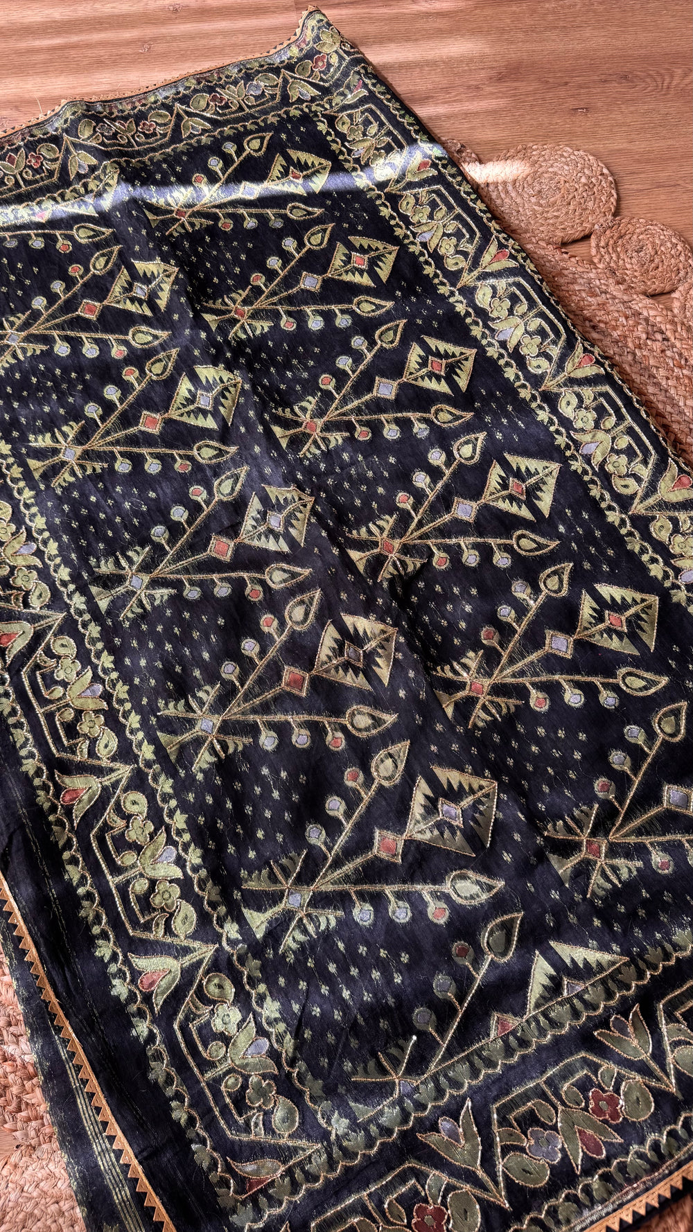 Full view of the grand pallu of the Black Kardana Jamdani Saree highlighting intricate tree-of-life geometric motifs and scalloped lace trim.