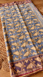 Full view of powder blue Kardana Jamdani saree spread out featuring golden leaf vine weave with hand-beaded detailing.
