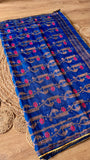 Top-angle view of the Royal Blue Kardana Jamdani Saree display, highlighting the continuous hand-embroidered vine motifs and gold triangle lace border.