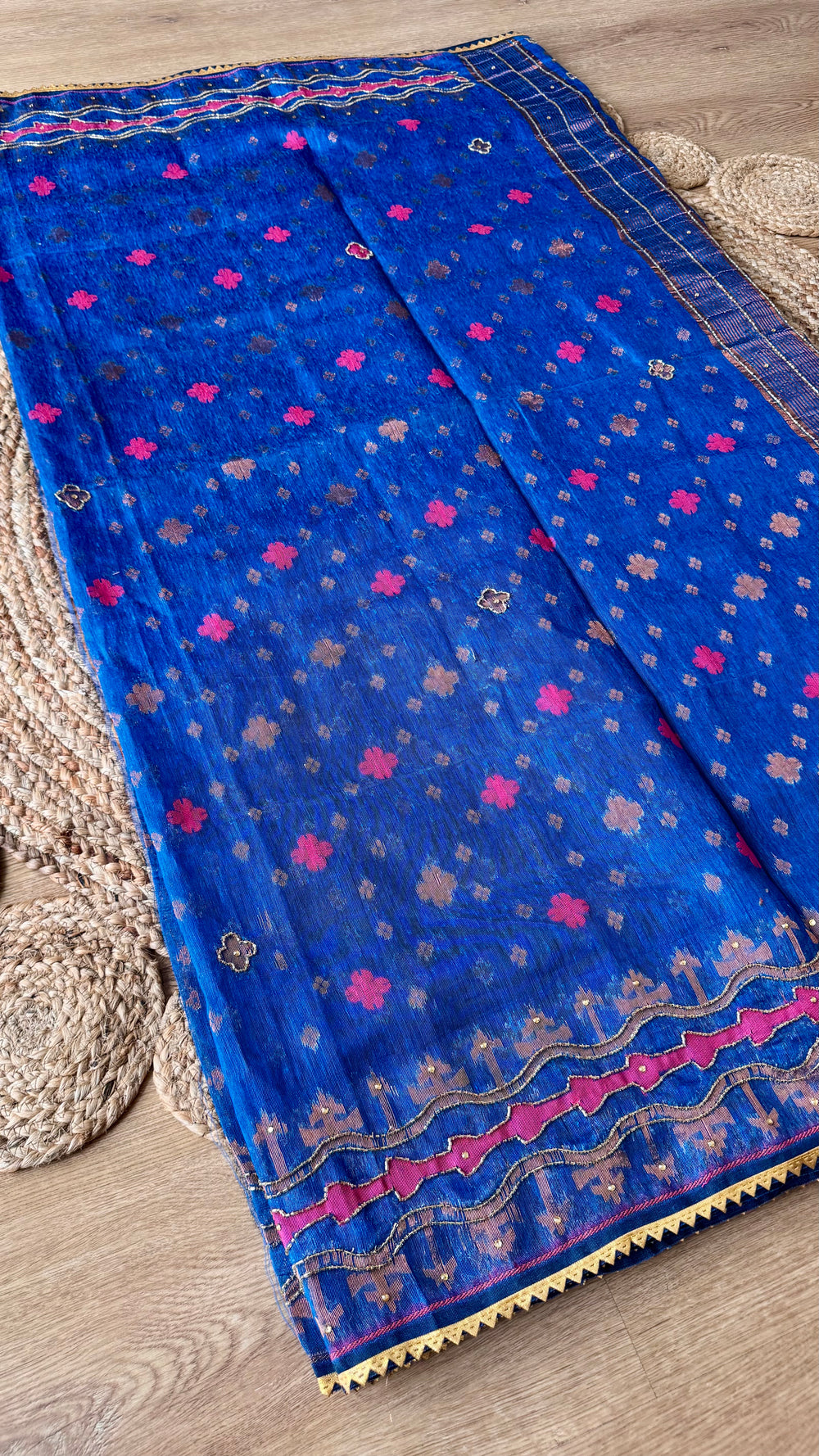 Full-length flat lay of the Royal Blue Kardana Jamdani Saree showcasing the all-over small floral bootis, wavy magenta lower border design, and sheer fabric texture.