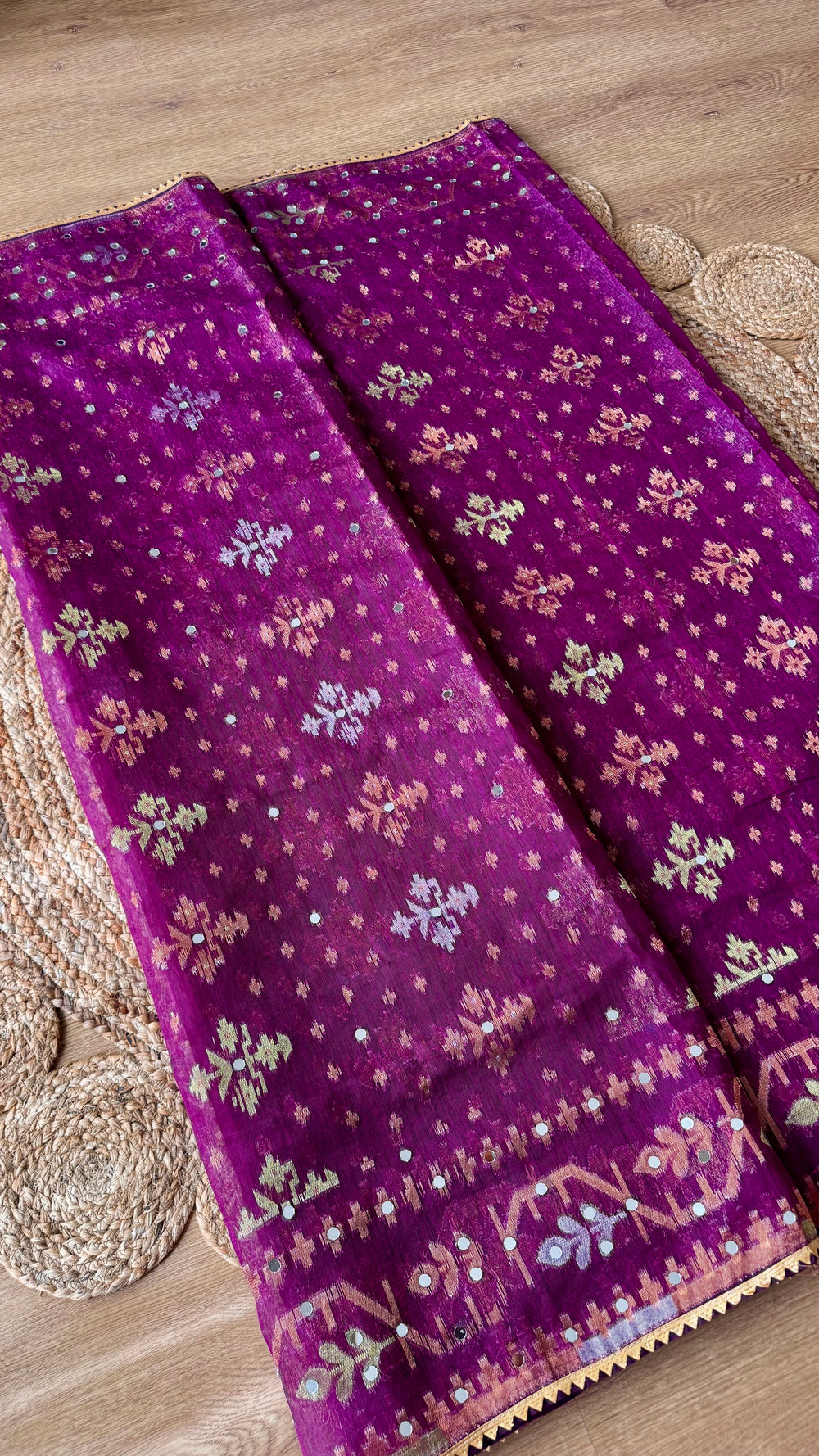 Close-up of Magenta Kardana Jamdani Saree body showing floral Jamdani motifs, subtle mirror work, and gold triangle lace edging.