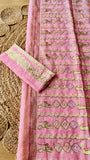 Fully opened pallu of pink kardana jamdani saree displaying intricate geometric diamond embroidery alongside matching embroidered blouse fabric.