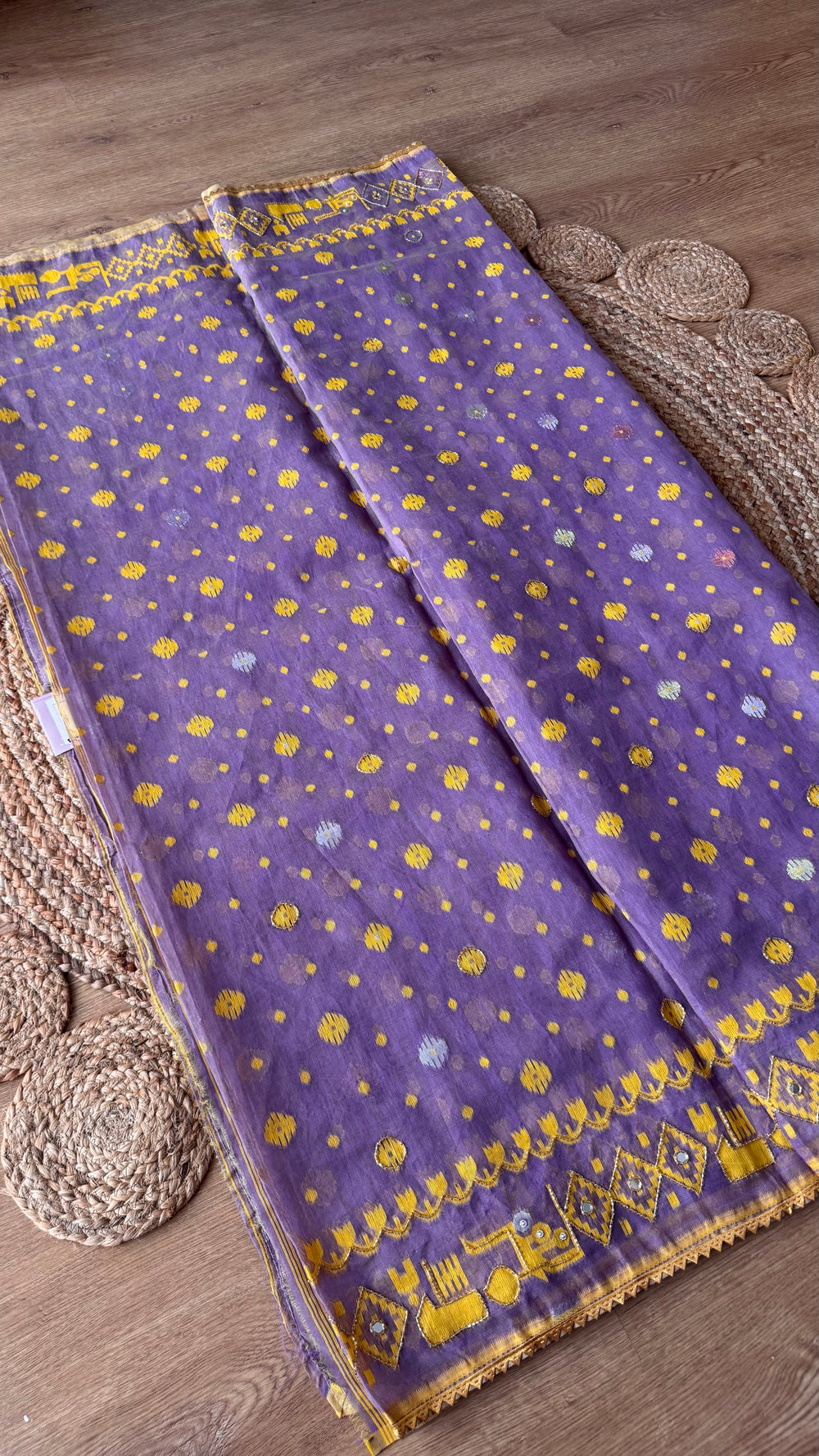 Full length view of the lavender Kardana Jamdani saree displayed flat showing all-over mustard yellow buttis and decorative lower border detailing.