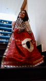 A woman smiling, draped in a Titafu Maheshwari Silk Saree, highlighting the flow of the fabric on a staircase.