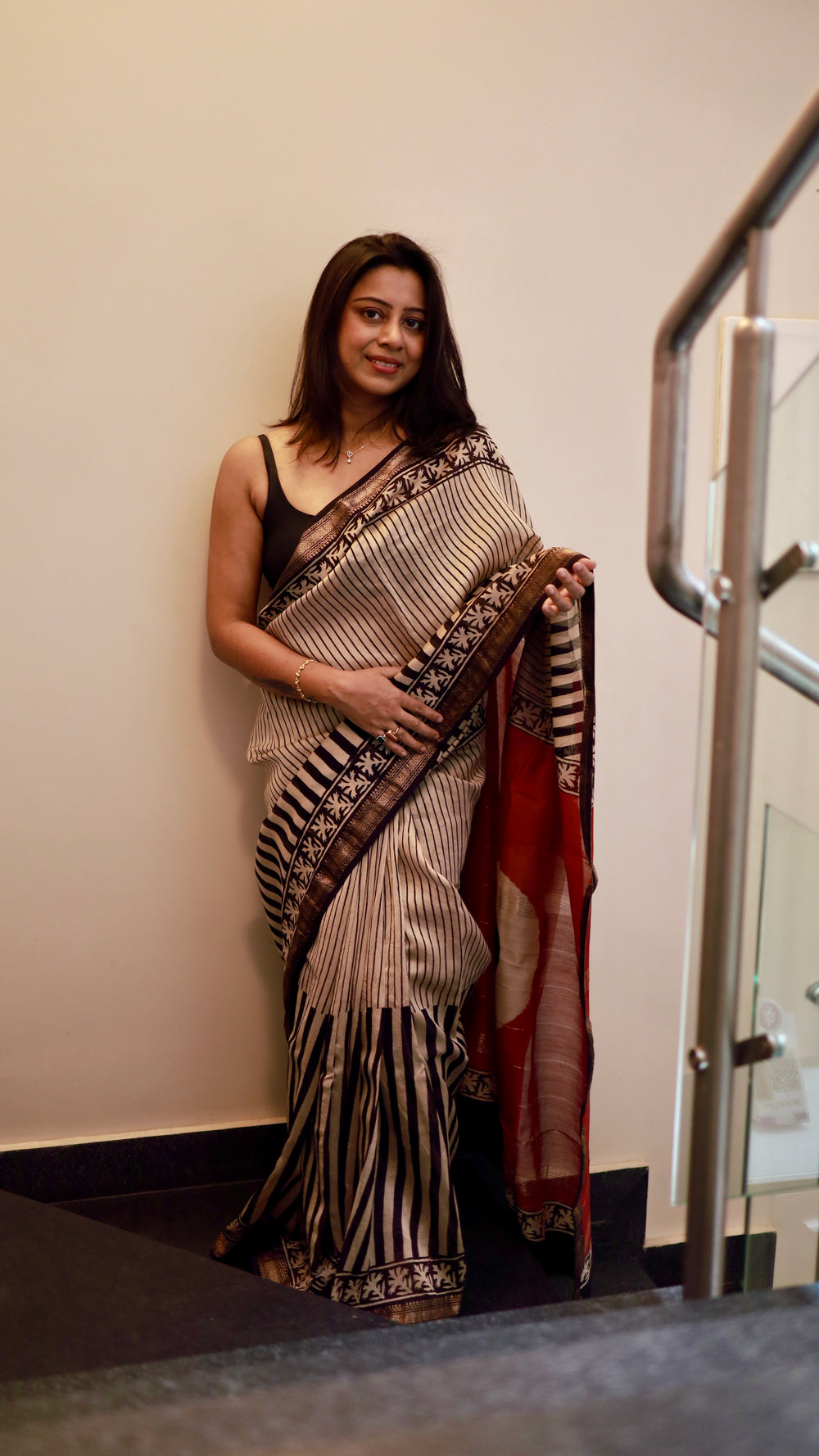 Frontal view of a model wearing a Titafu designer saree, showcasing the drape and professional ethnic styling.