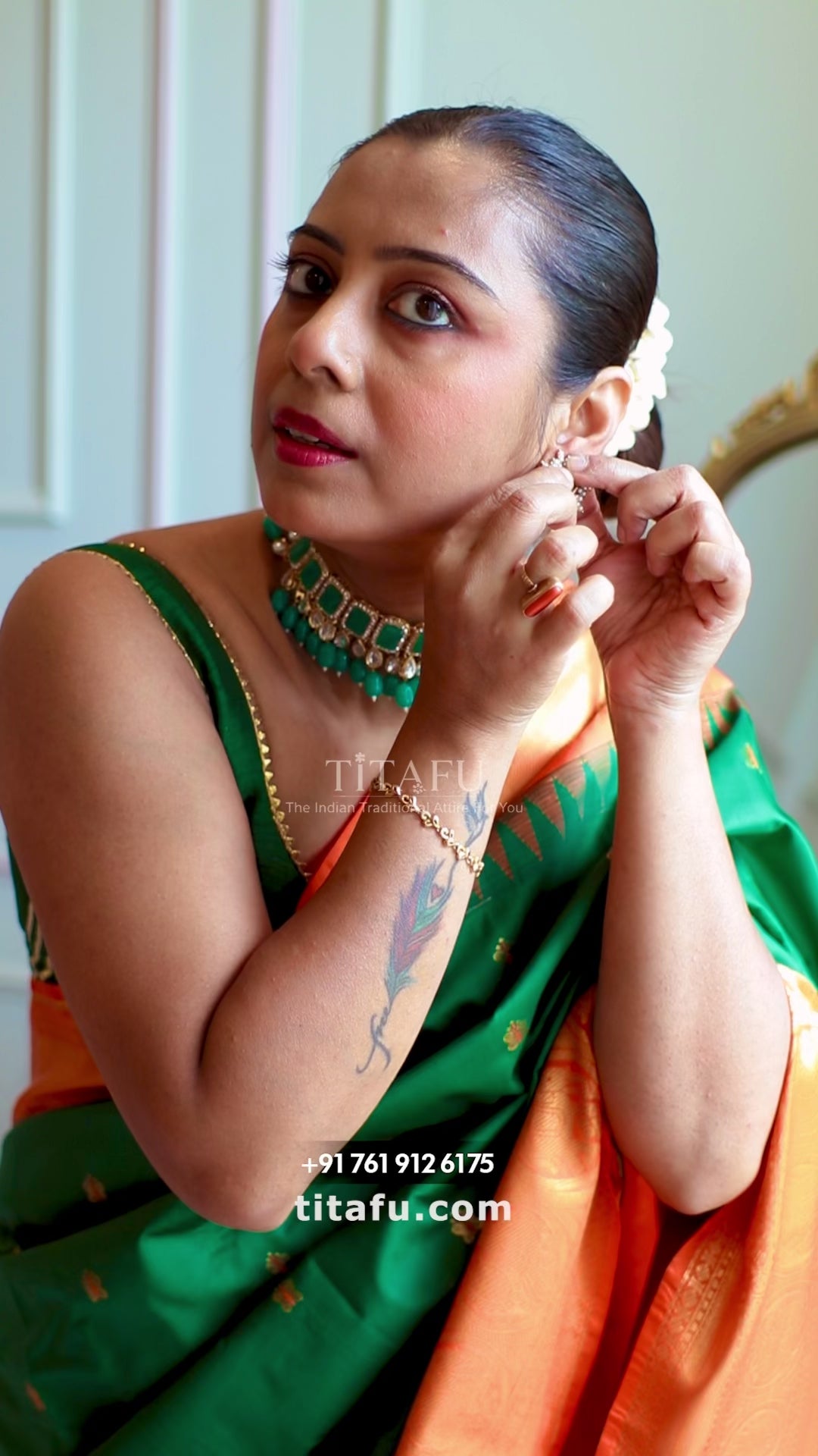 Detailed look at the woven peacock motifs along the contrast orange zari pallu and body buttis of the Titafu semi Gadwal saree.